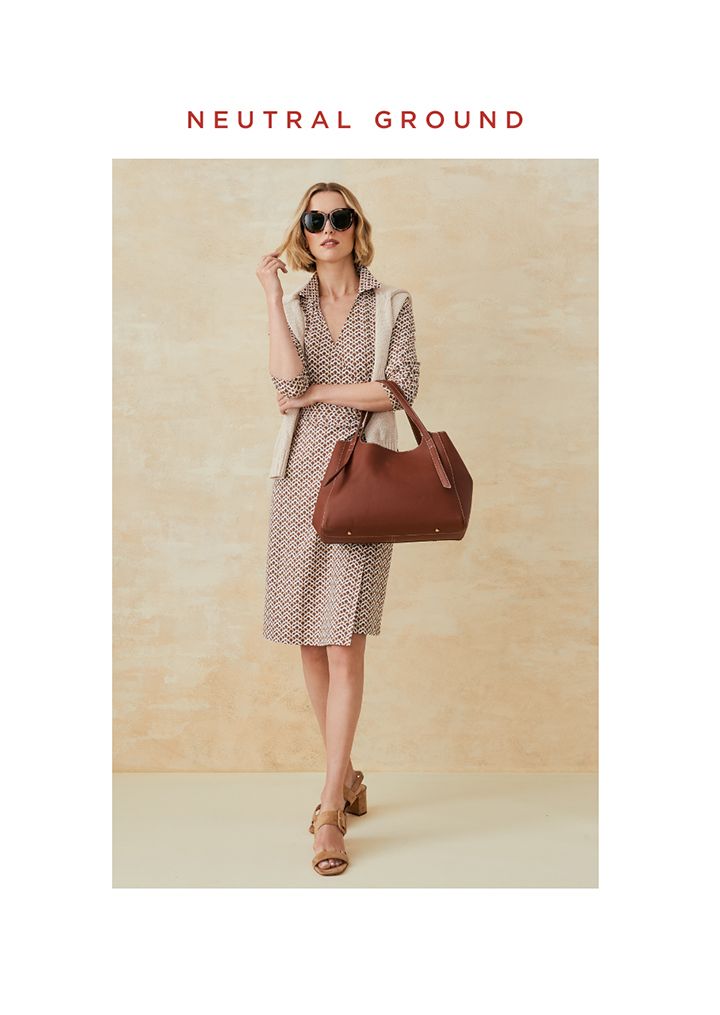 Woman standing in a brown and white wrap dress
