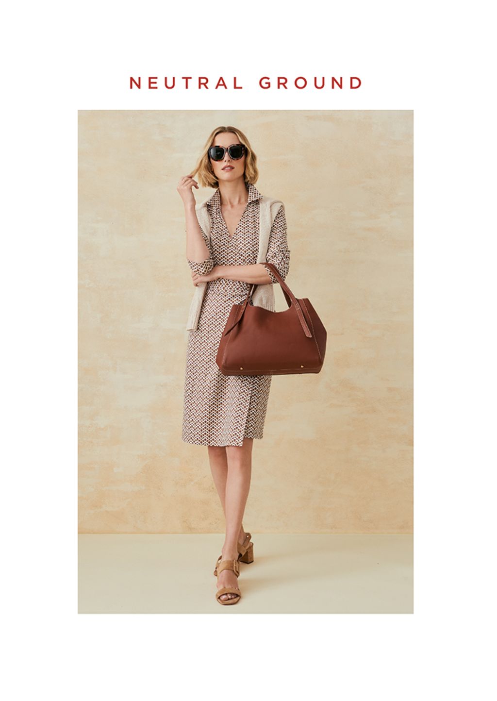 Woman standing in a brown and white wrap dress