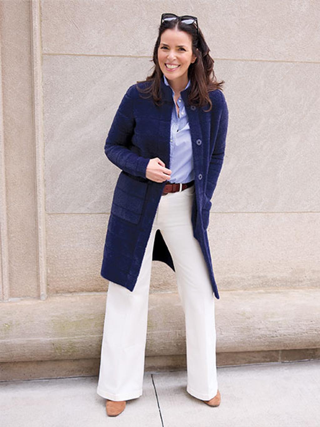Model wearing Tripp cardi-coat in navy, blue shirt, and white jeans