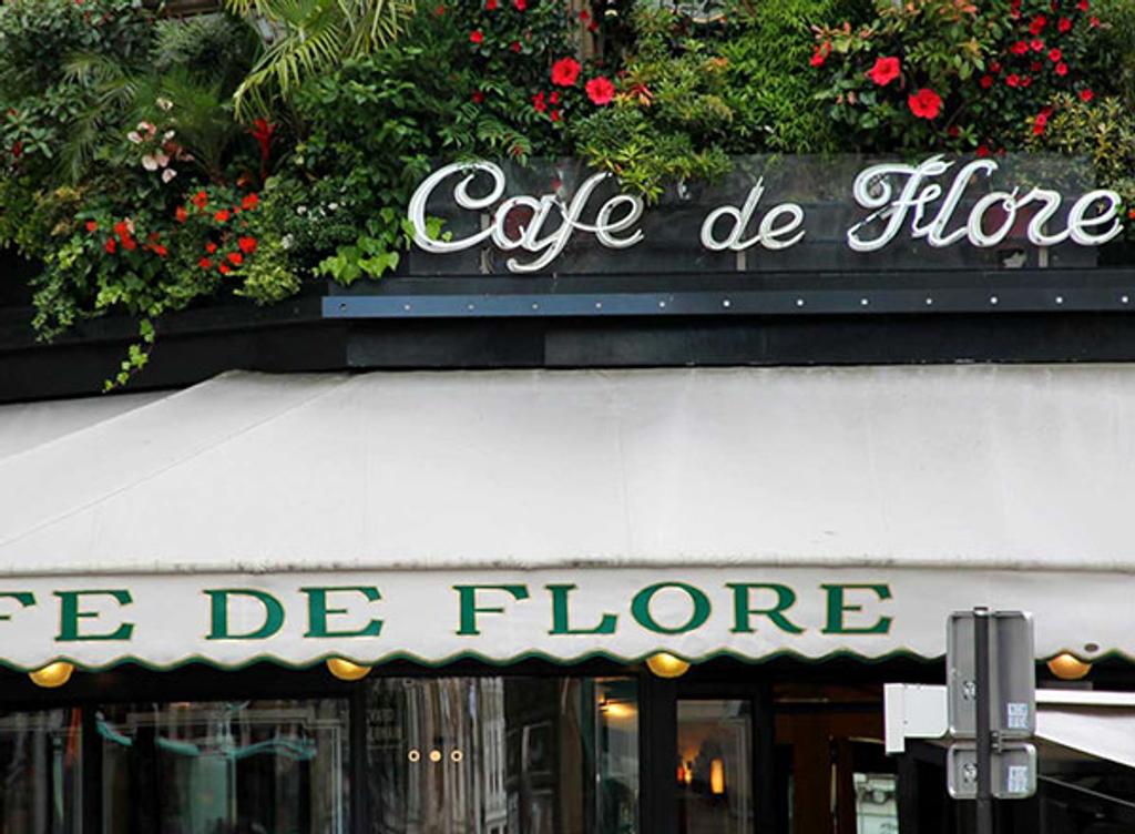 Exterior shot of Cafe de Flore with canopy and flowers Exterior shot of Cafe de Flore with canopy and flowers