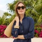 woman holding natural wicker bag over her shoulder