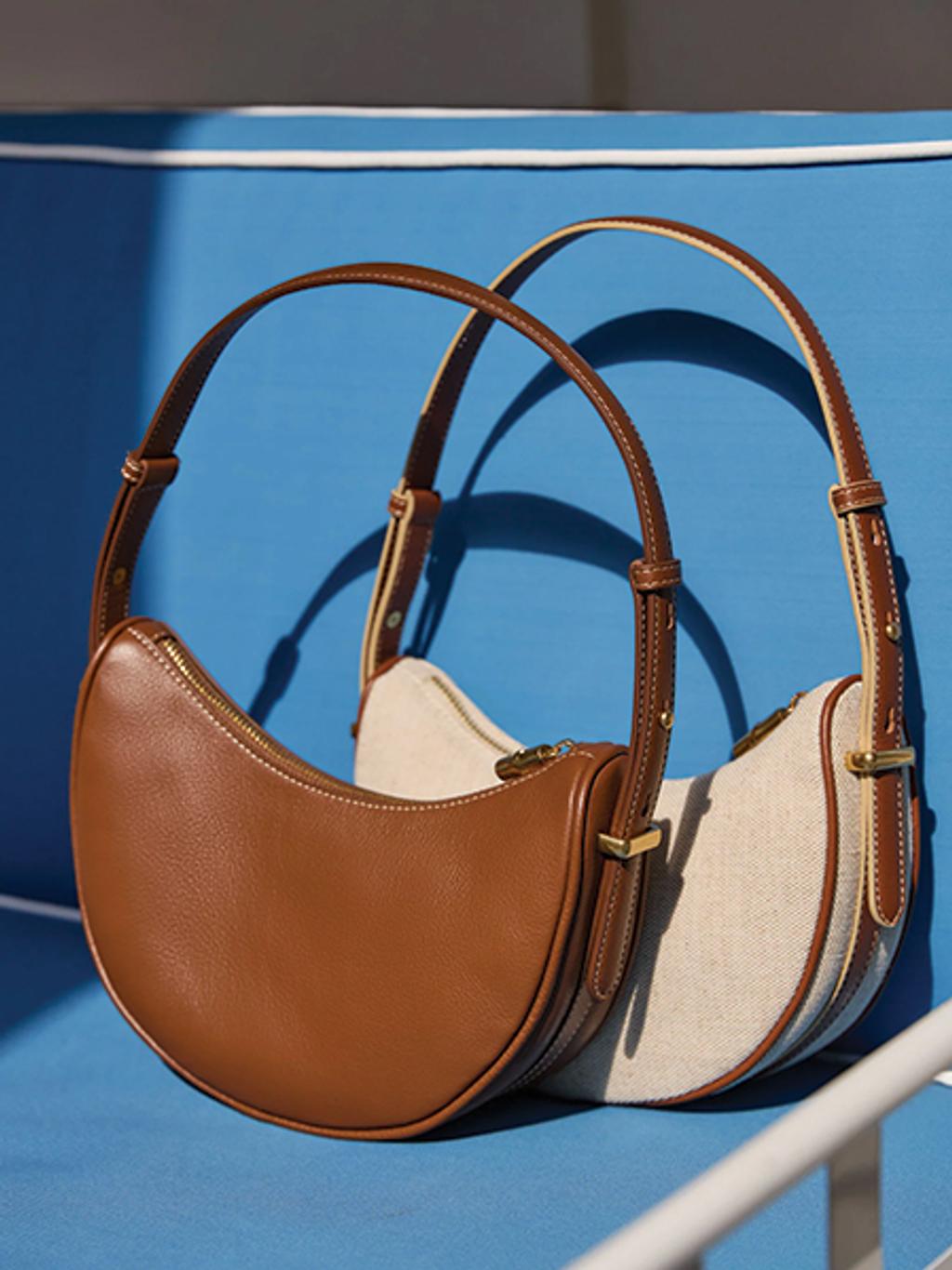 Still shot of two crescent shoulder bags