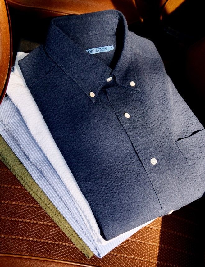 stack of mens shirts in various colors