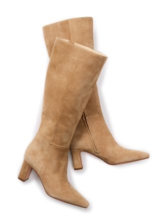 still life of womens light tan suede tall boots