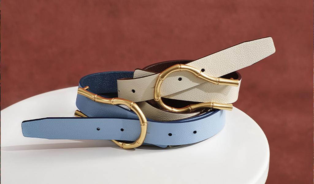 Blue and white belt stacked on top of one another on side table.