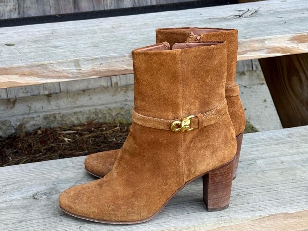 Brown suede ankle boots with a gold-tone buckle.