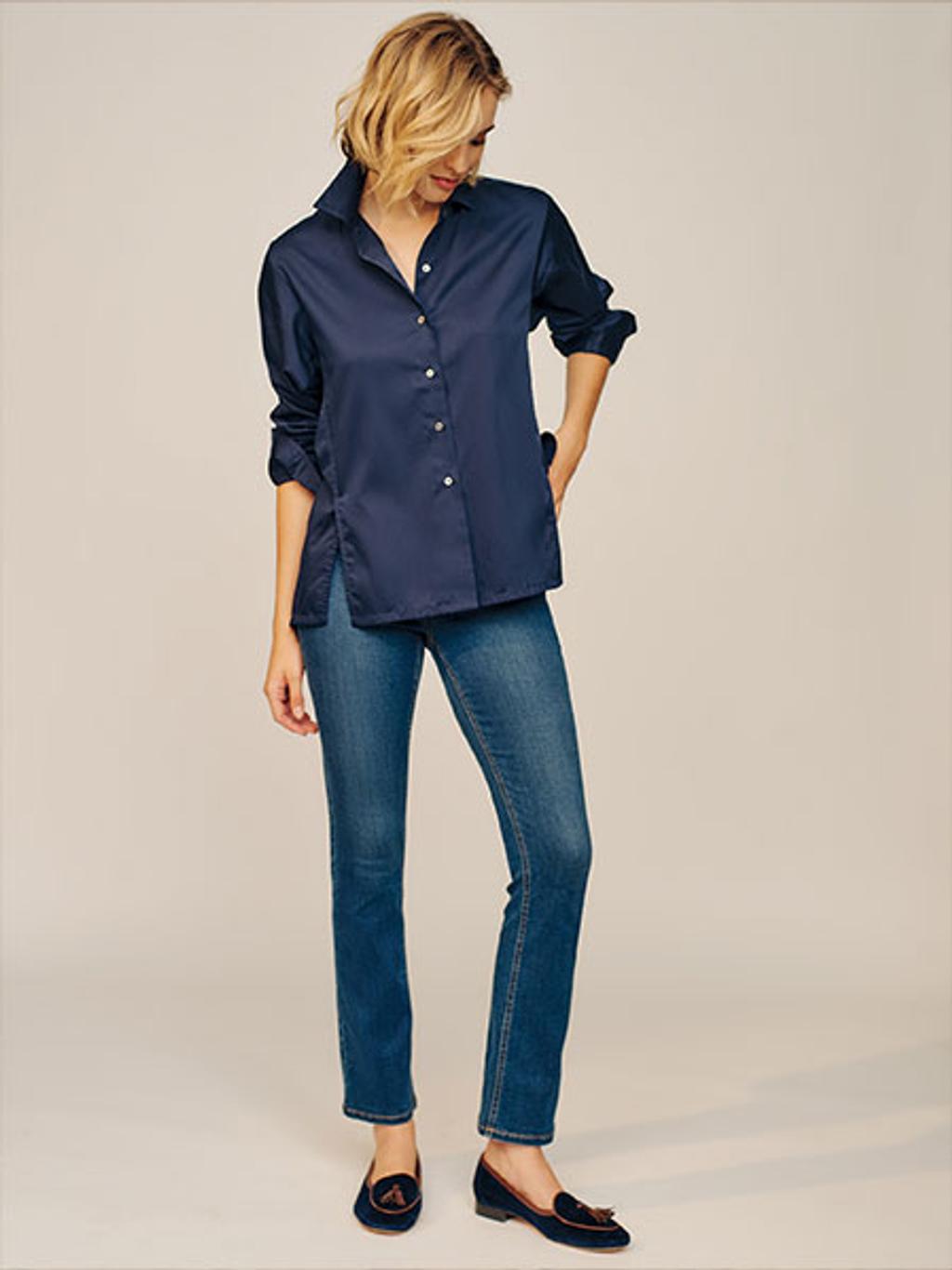 Model in navy shirt, jeans, and loafers Model in navy shirt, jeans, and loafers