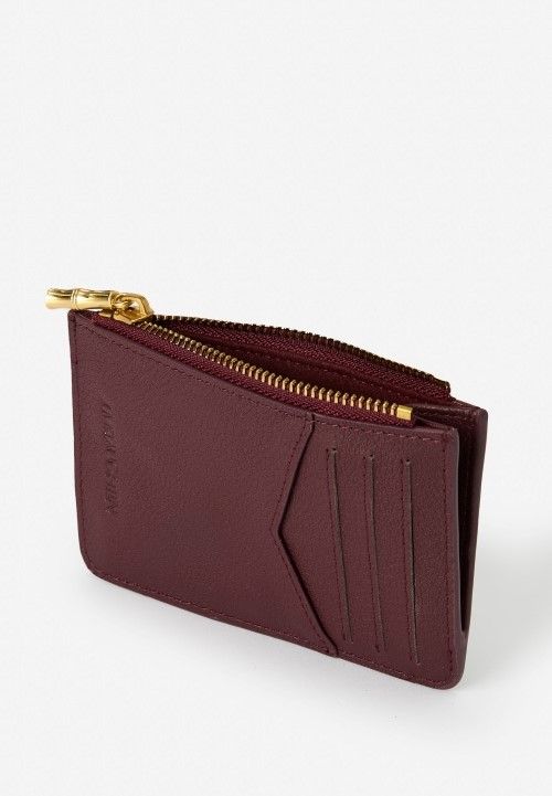 laydown of womens burgundy leather zip card case and wallet