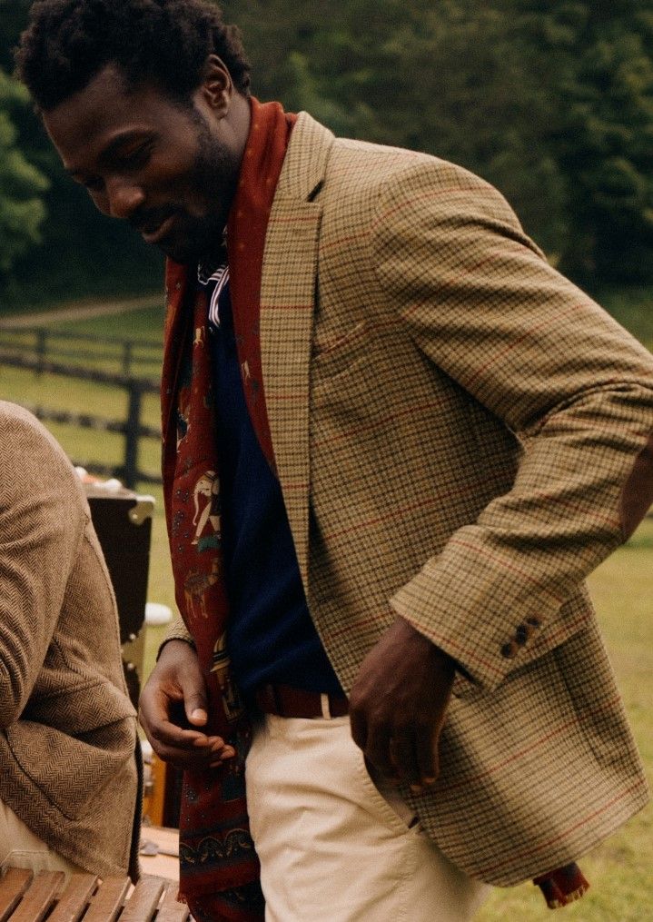 man standing outside in check blazer, khaki chino and burgundy patterned scarf