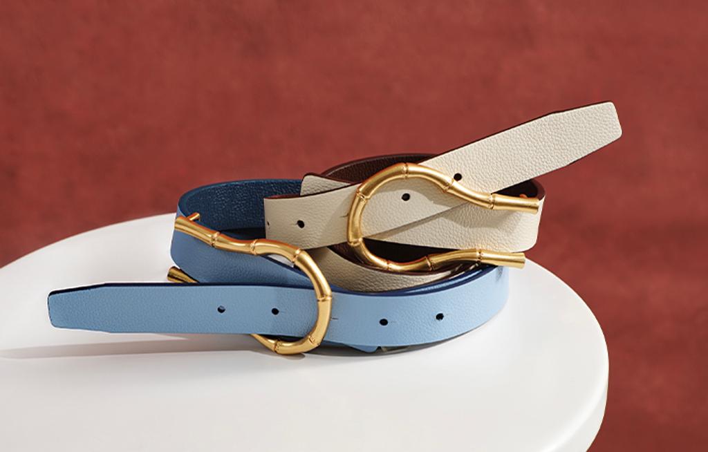 Blue and white belt stacked on top of one another on side table.