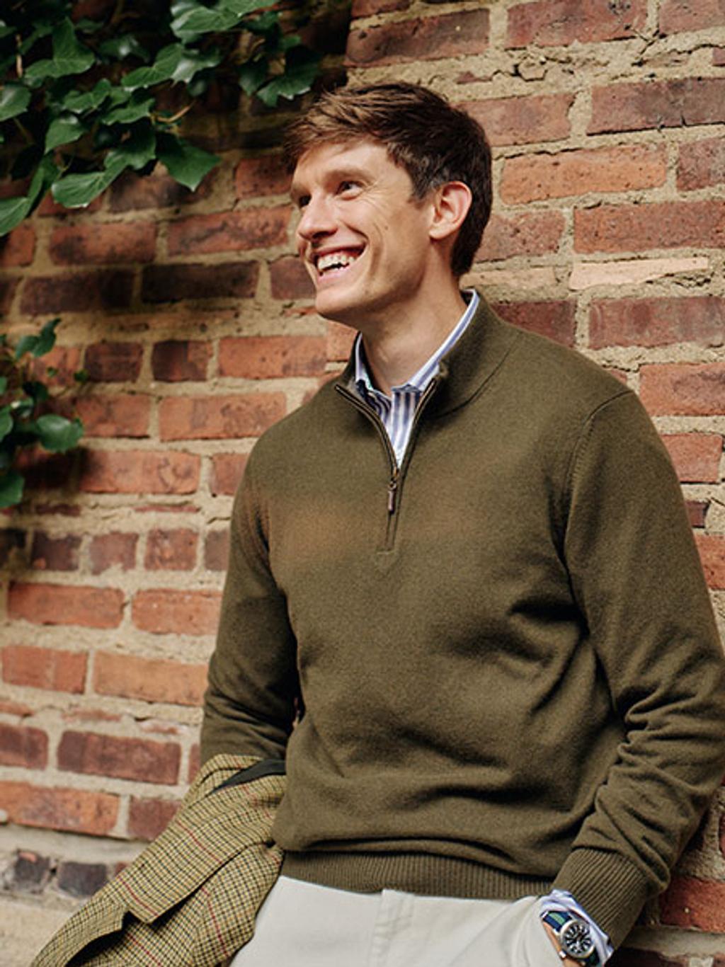 Model a green quarter zip sweater.
