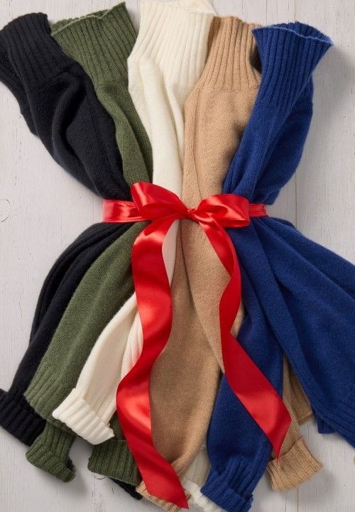 group of womens cashmere turtleneck sweaters in various colors, tied with a bow