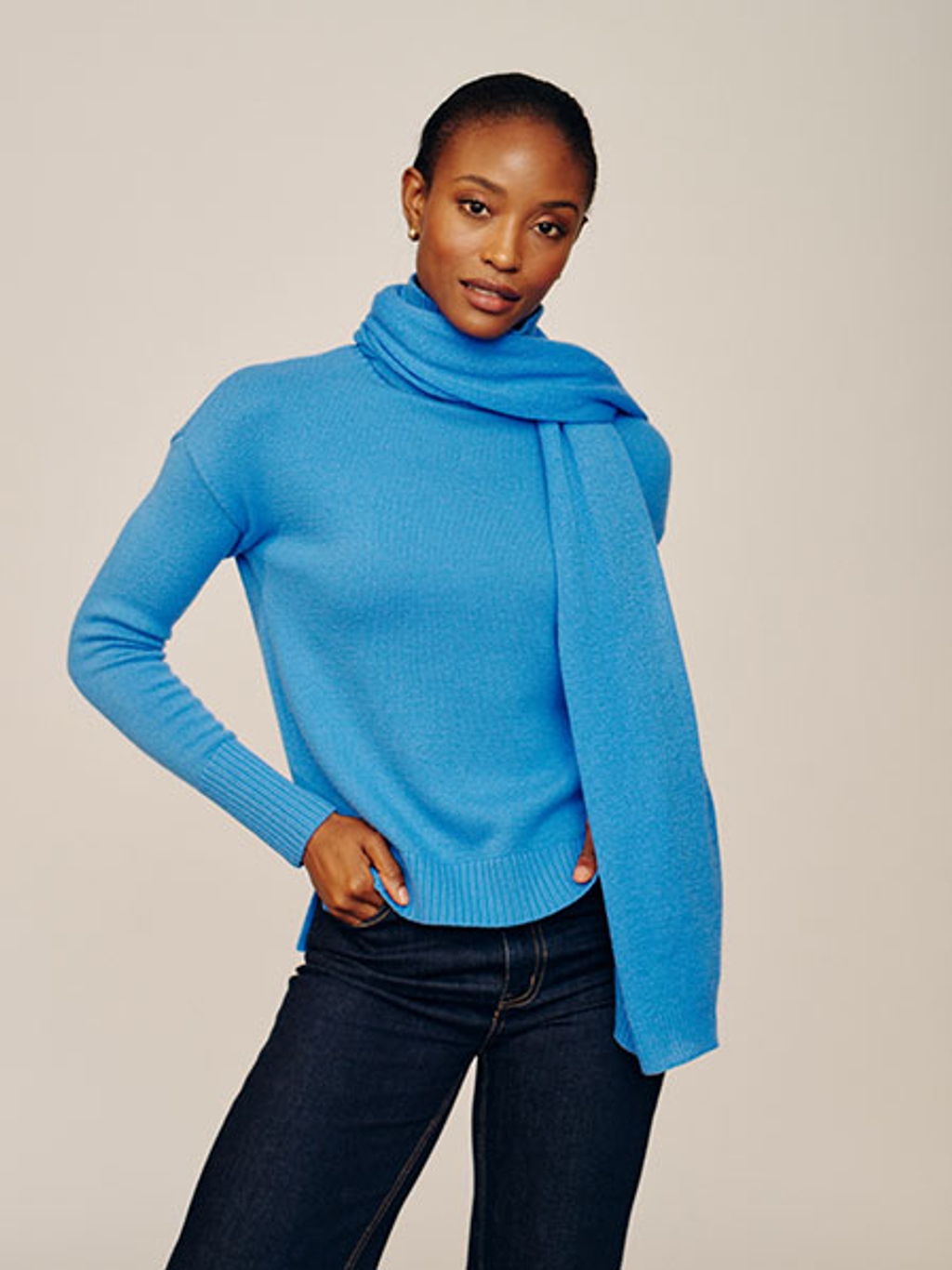 Model in blue cashmere sweater and scarf