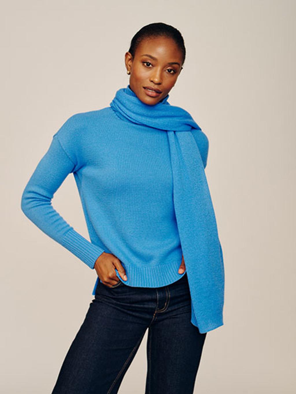 Model in blue cashmere sweater and scarf