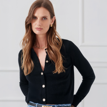 cropped in image of woman wearing cashmere black cardigan with jewel buttons