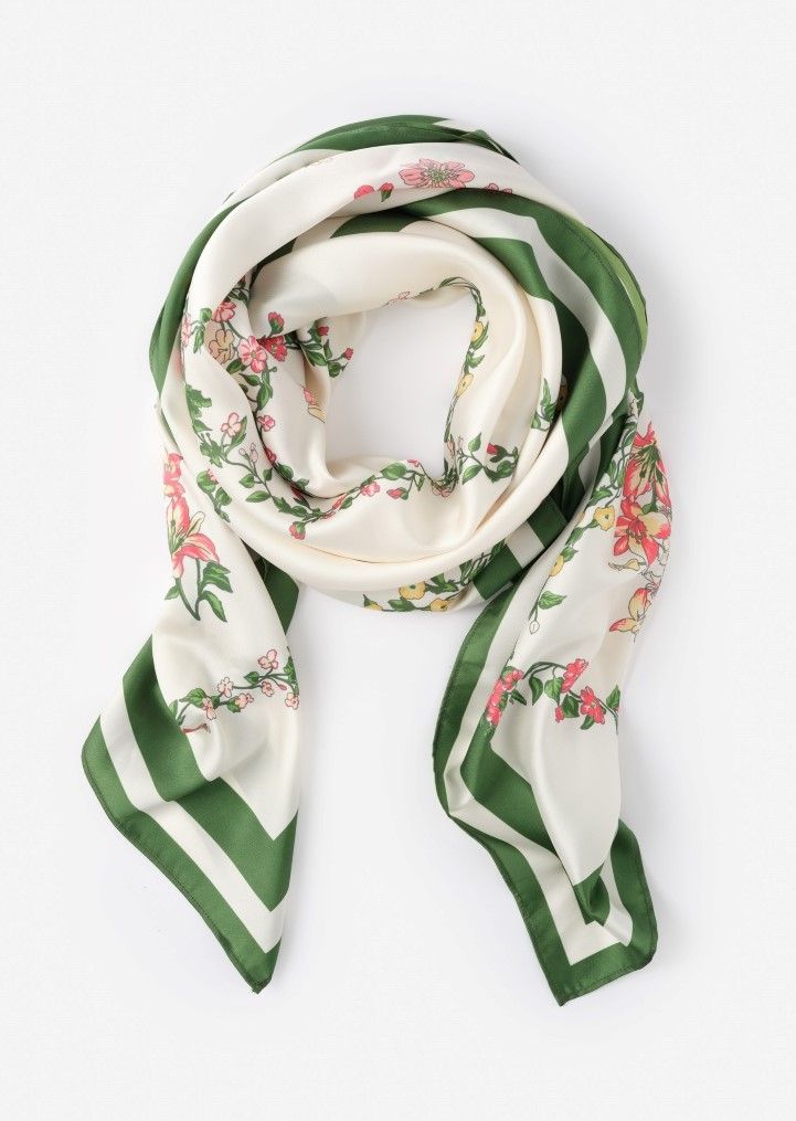 Cream scarf with green striped border and floral print.