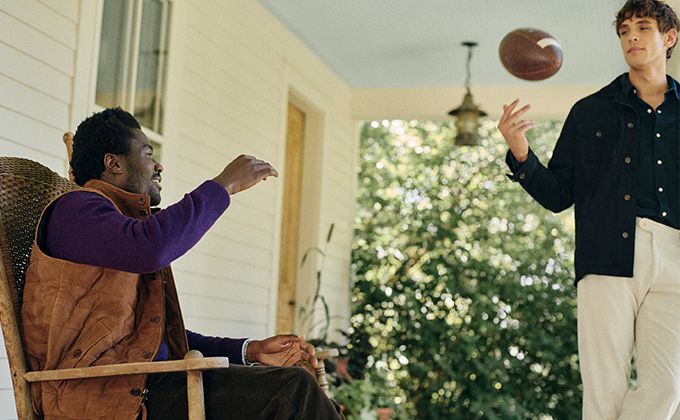 2 models wearing jackets playing football
