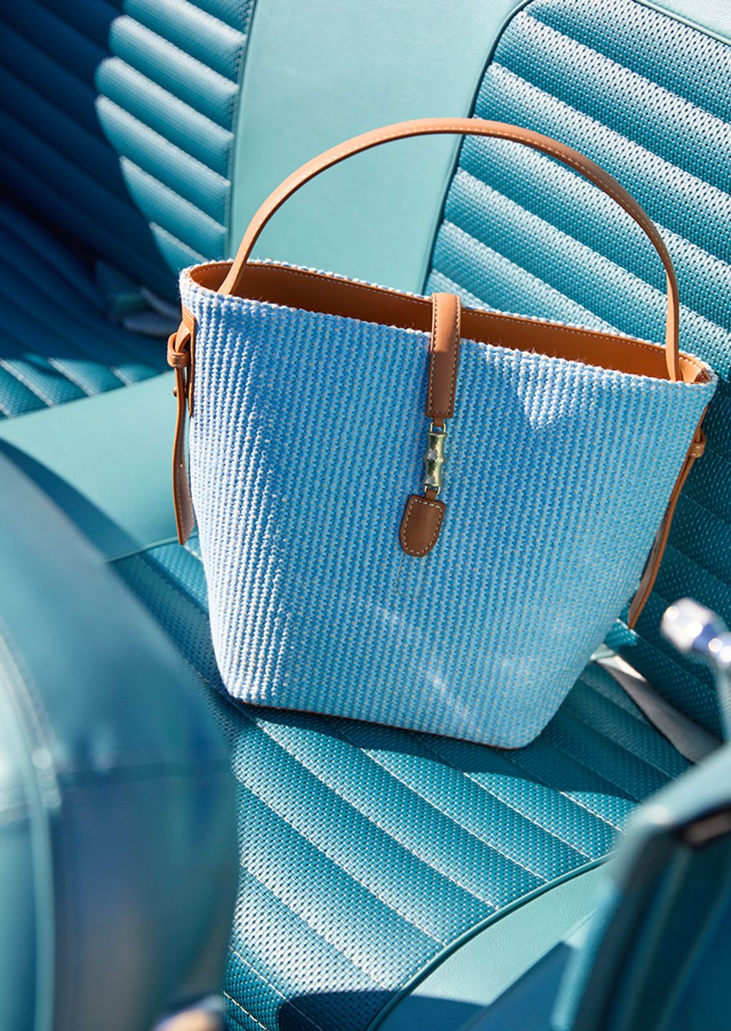blue purse sitting on blue leather seat