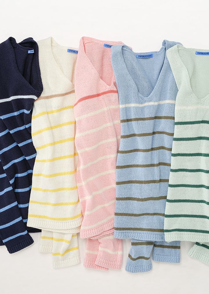 Five striped V-neck sweaters in navy, cream, pink, light blue, and light green.