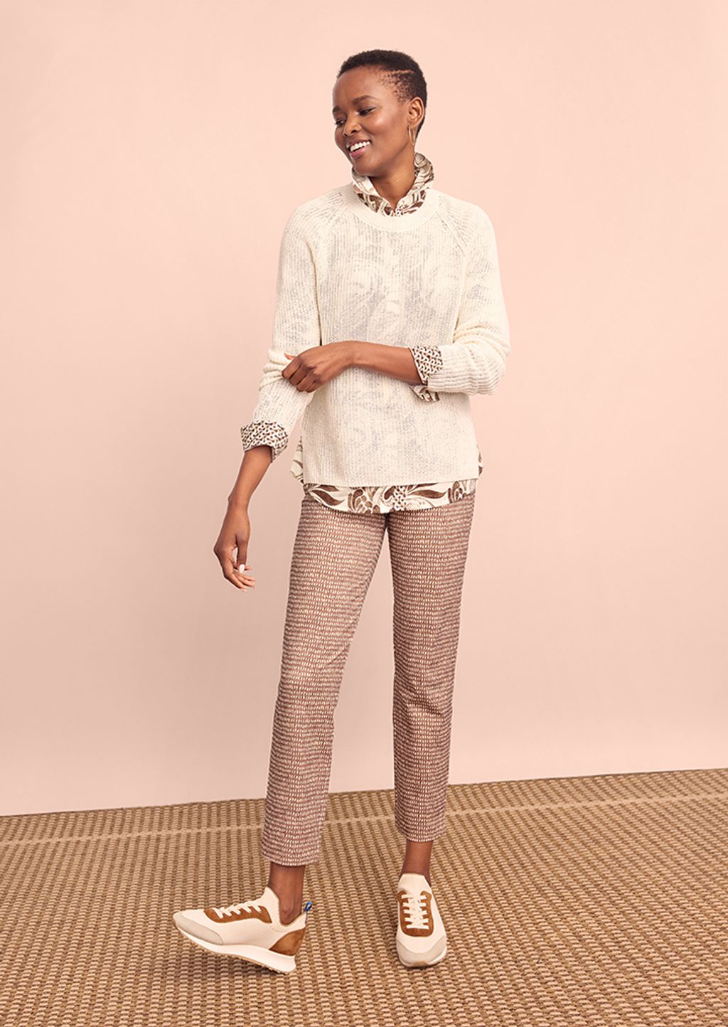 Model wearing sweater, pants and sneakers