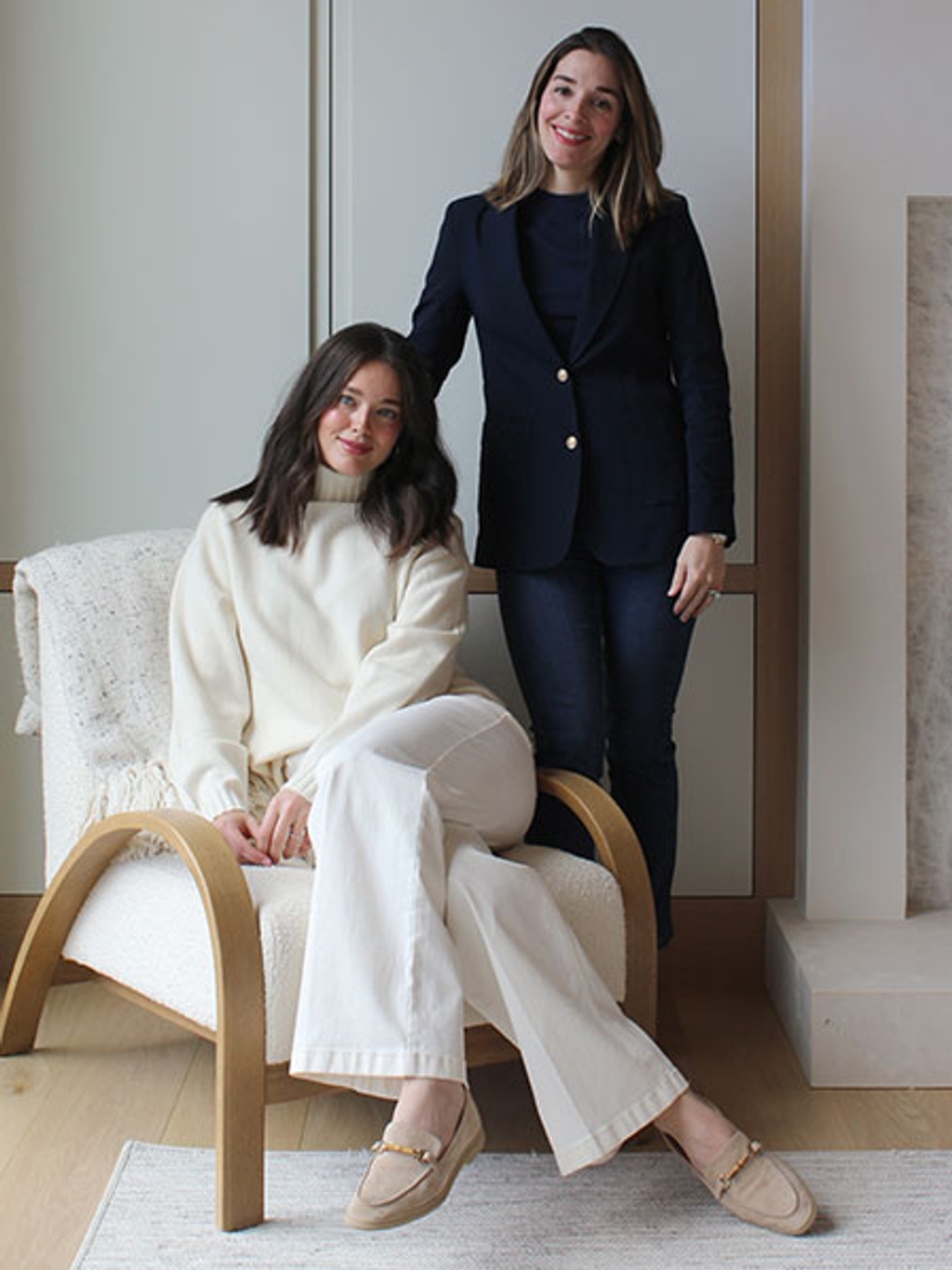 Emily in ivory sweater and white jeans. Christina in navy blazer, navy sweater, and jeans. Emily in ivory sweater and white jeans. Christina in navy blazer, navy sweater, and jeans.