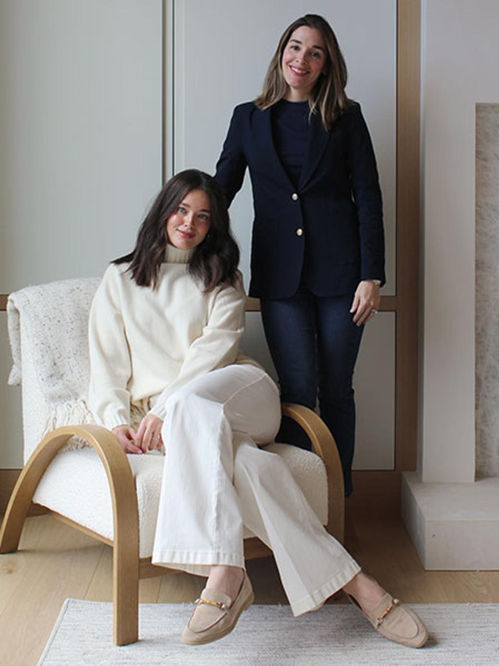 Emily in ivory sweater and white jeans. Christina in navy blazer, navy sweater, and jeans. Emily in ivory sweater and white jeans. Christina in navy blazer, navy sweater, and jeans.