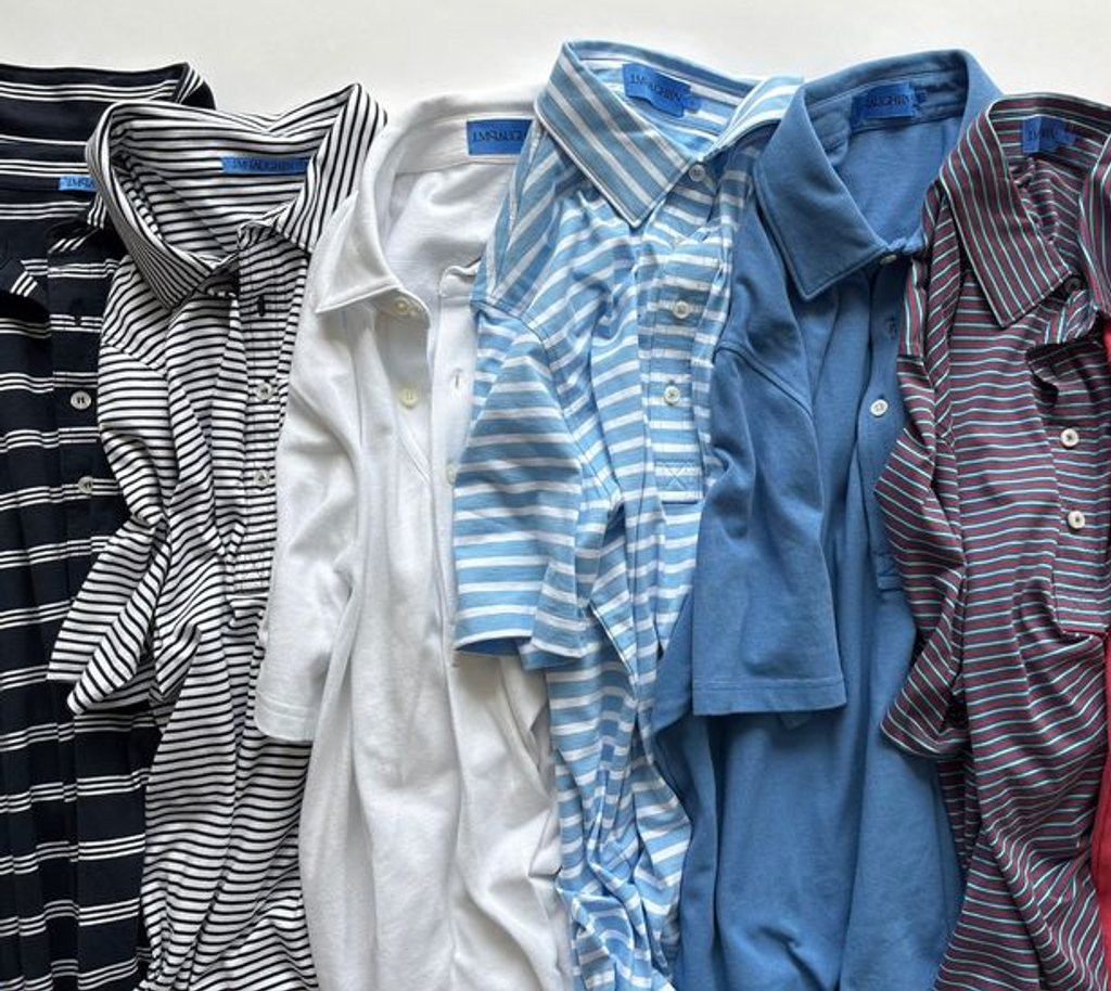 A row of seven men's polo shirts in various solid colors and stripes.