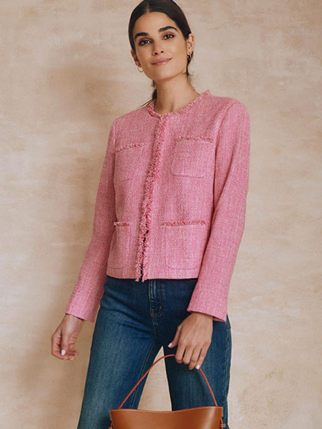 Model wearing pink tweed jacket and jeans.