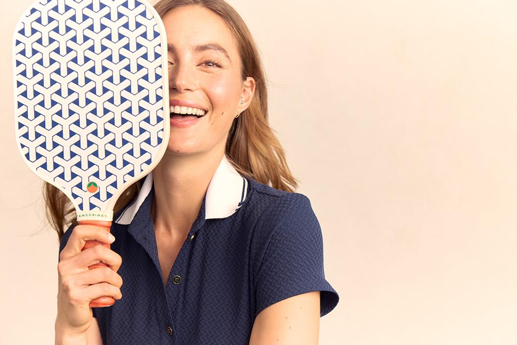 Model holding limited-edition pickleball paddle.
