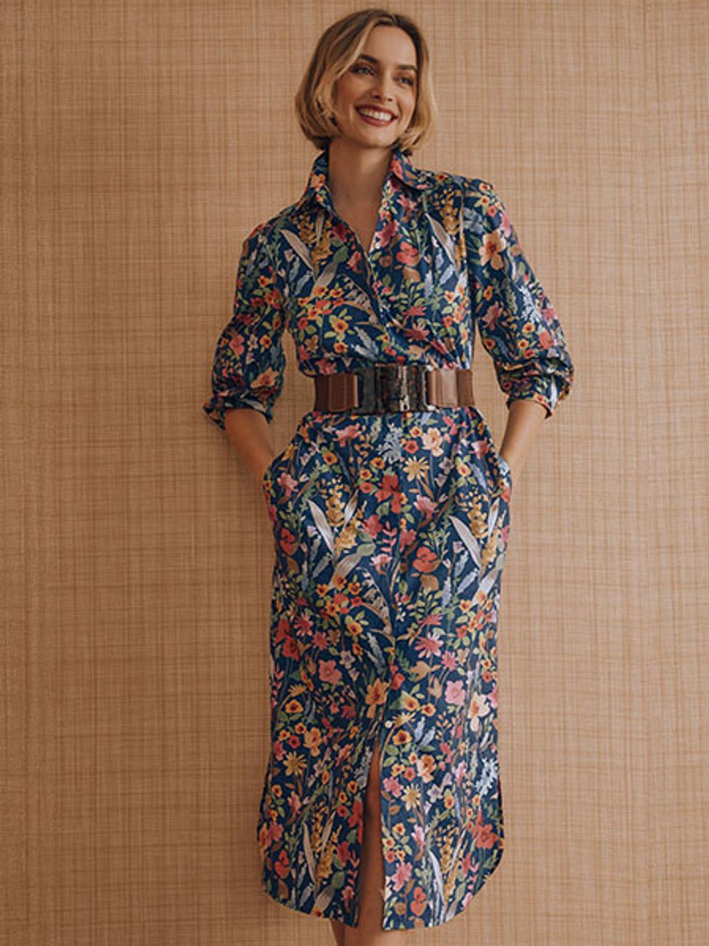 Women with short blonde hair wearing a floral midi dress.