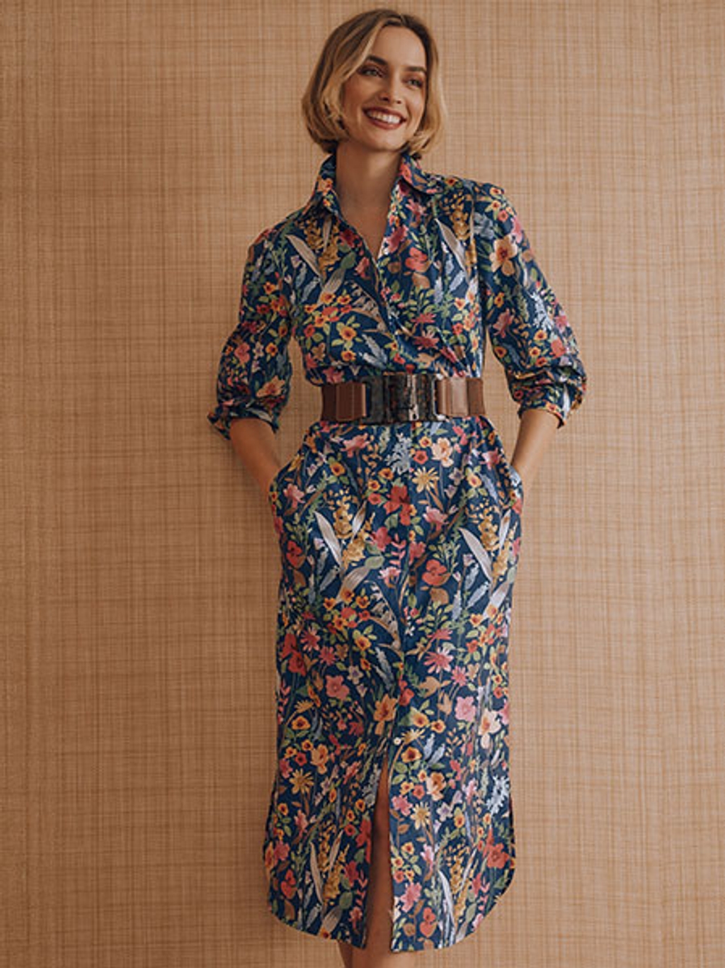 Women with short blonde hair wearing a floral midi dress.
