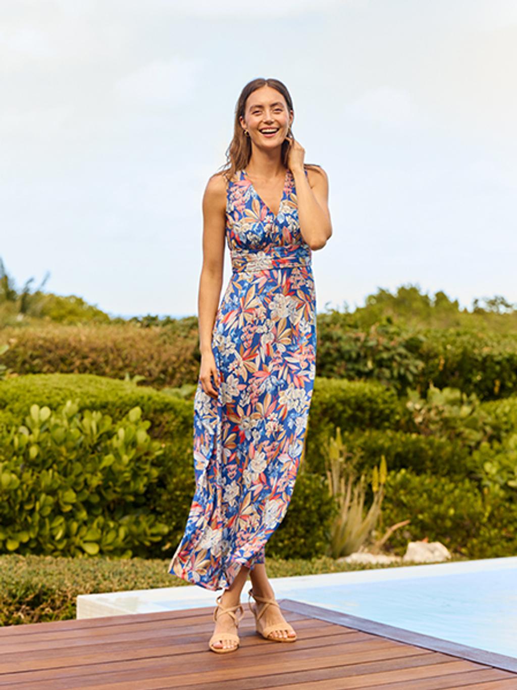 Model wearing floral maxi dress and leather heels.