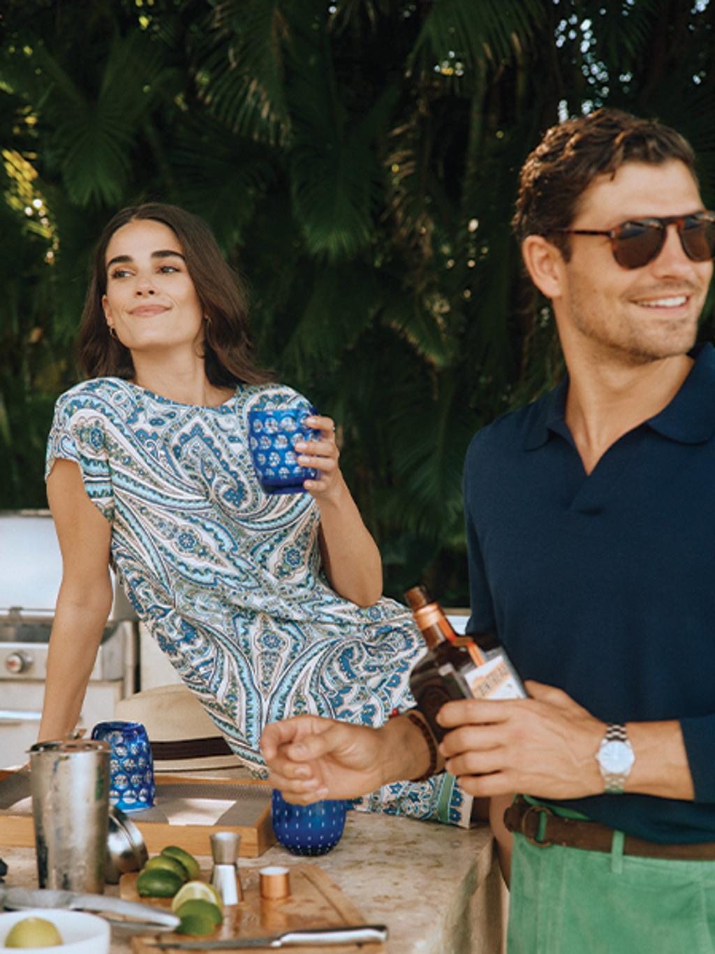 Female model drinking margarita. Male model next to her.