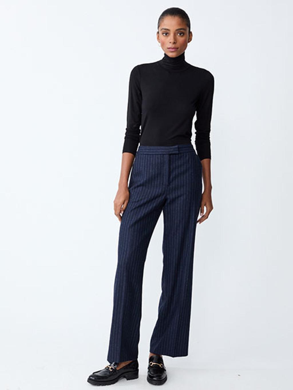 Model in black turtleneck and navy pinstripe pants