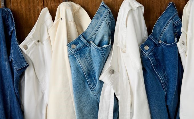 row of jeans hanging on wall