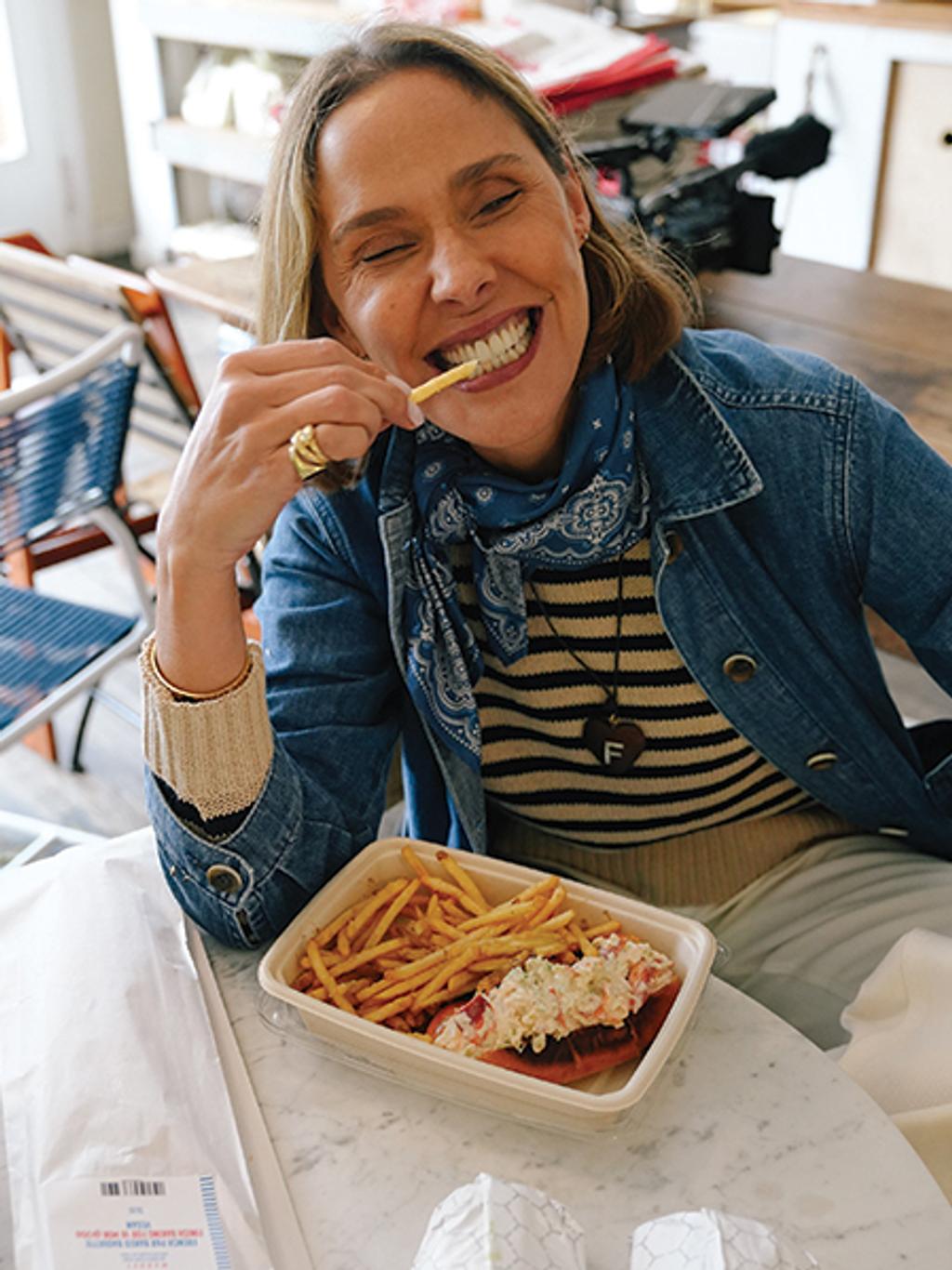 Filipa de Abreu eating lobster roll and fries