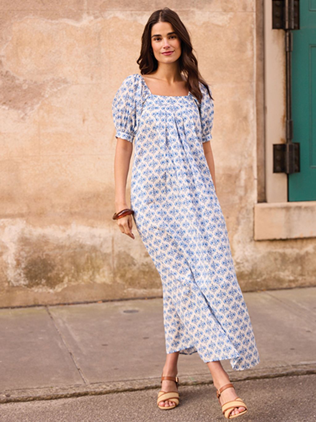 Model in floral puff-sleeve maxi dress and block heels