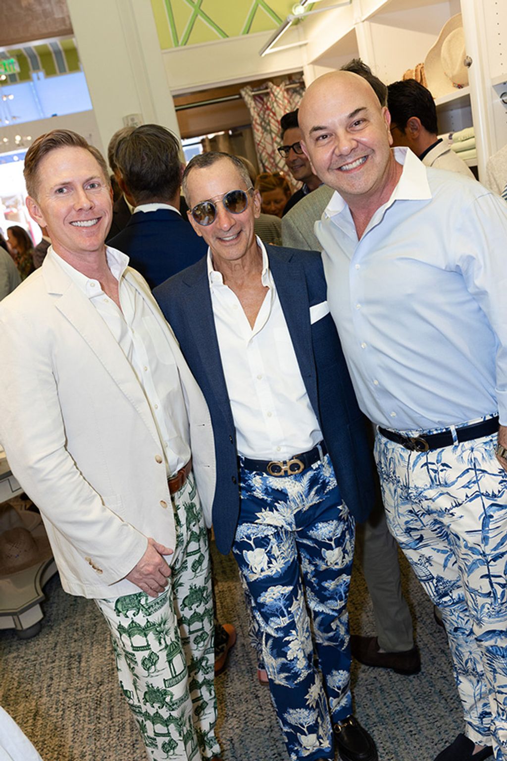 Three men pose together for photo