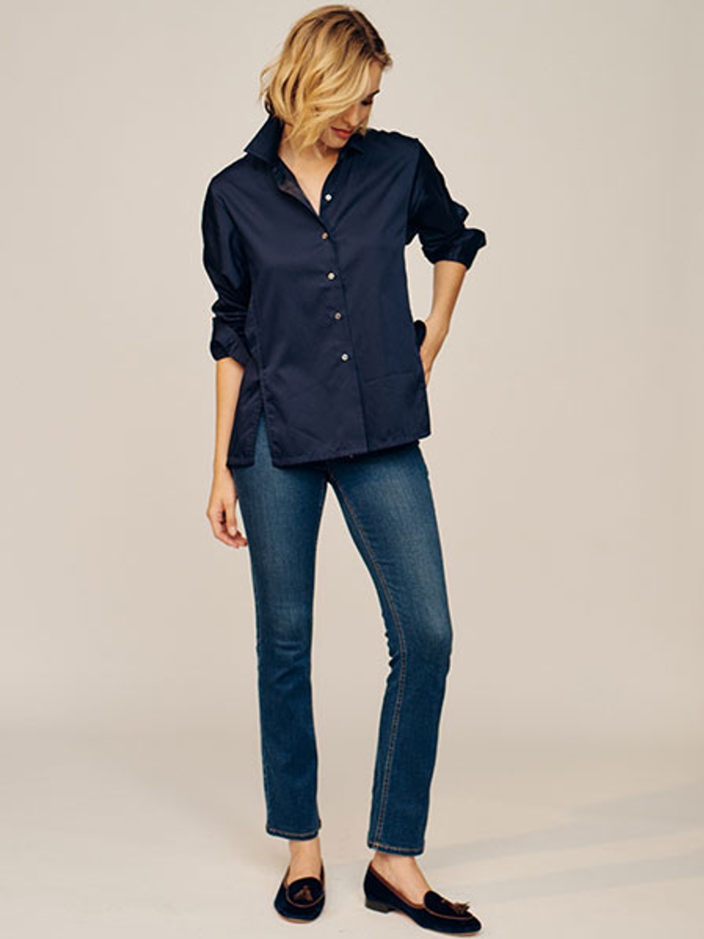 Model in navy button-down and jeans