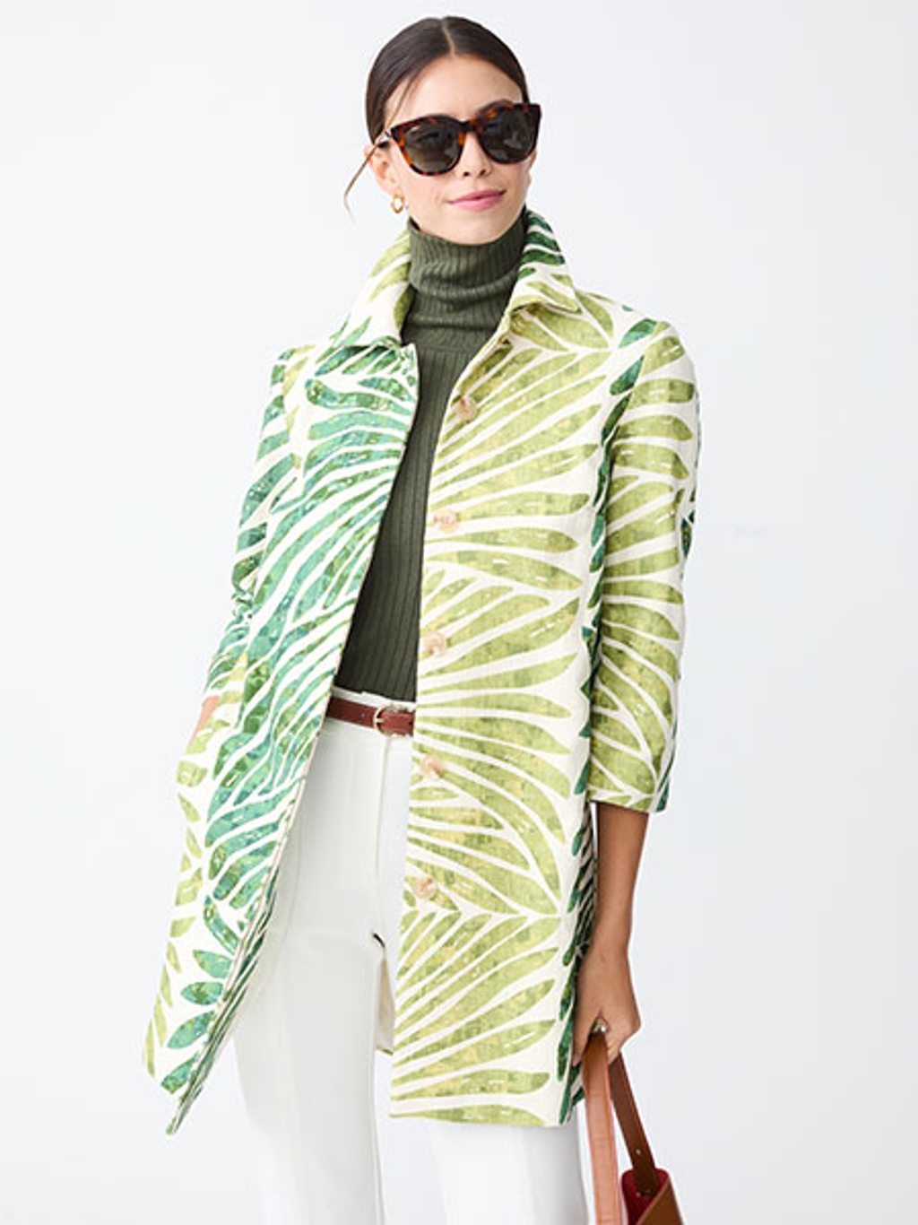Model in palm-print coat, turtleneck, pants, and sunglasses Model in palm-print coat, turtleneck, pants, and sunglasses
