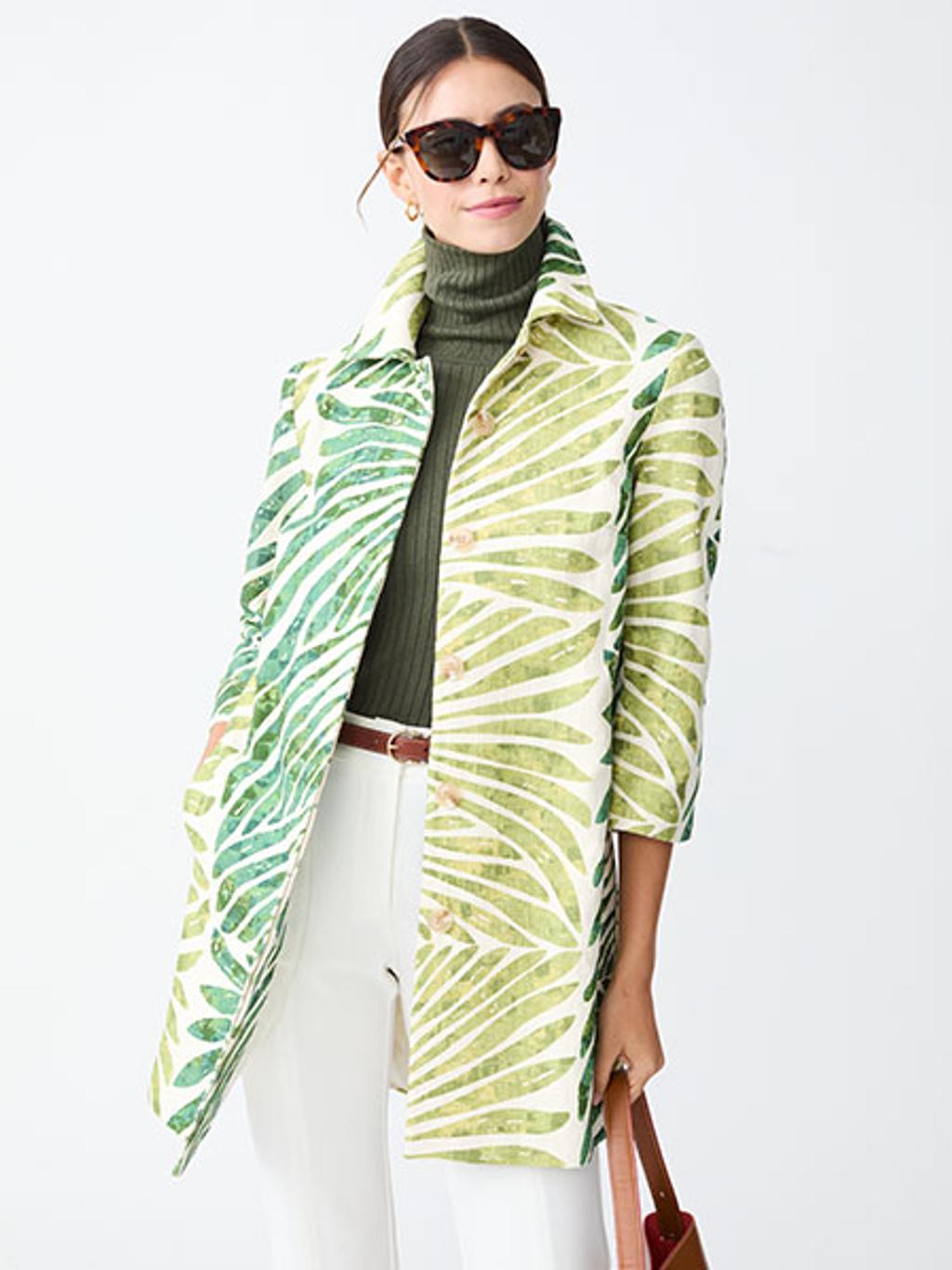 Model in palm-print coat, turtleneck, pants, and sunglasses Model in palm-print coat, turtleneck, pants, and sunglasses