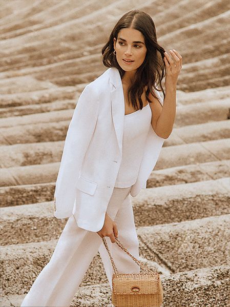 Model in white three-piece matching suit set