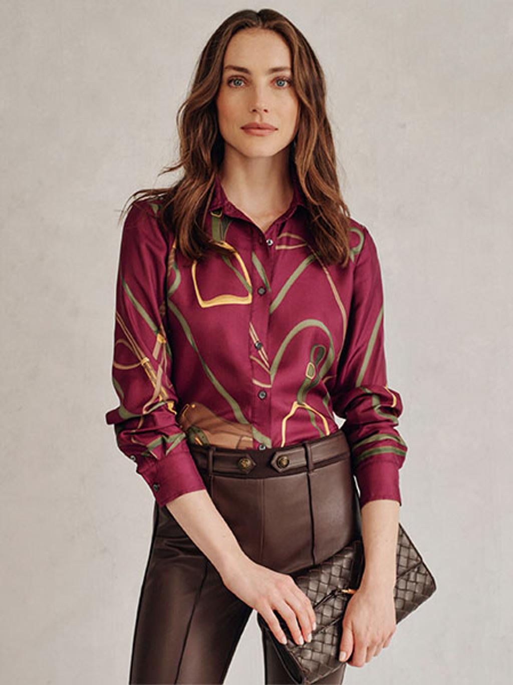 Model wearing printed blouse and faux-leather leggings