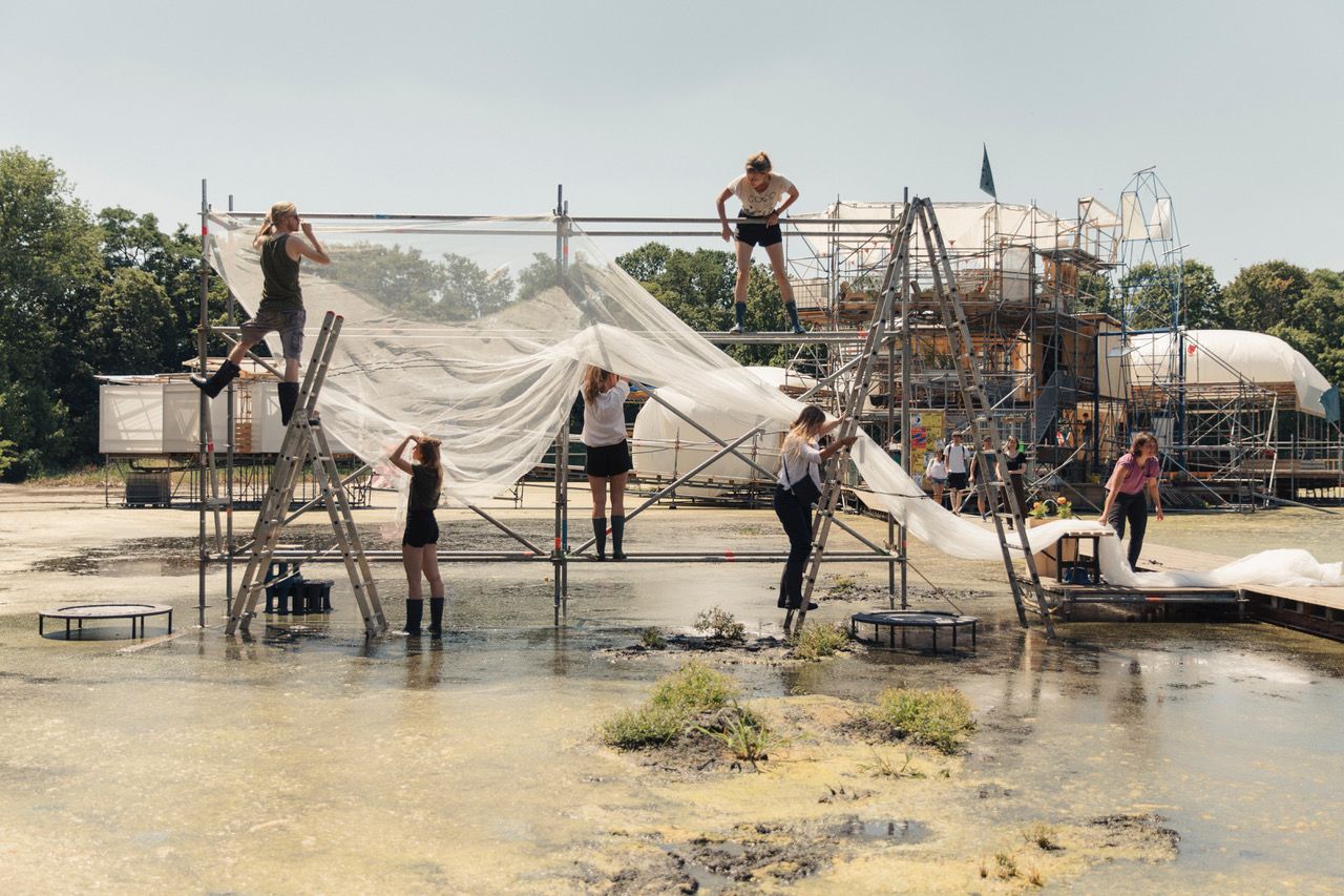 Collective Design Process at Floating University Berlin  As the land becomes liquid, an association inquires what to build, where to build, and how to build     Water in Berlin is complicated to say the least. In parts of the city the groundwater is dropping. In other parts of the city the groundwater is rising and must be pumped out. Blue pipes, suspended in the air, flow through city streets, rescuing buildings and streets as the land becomes liquid