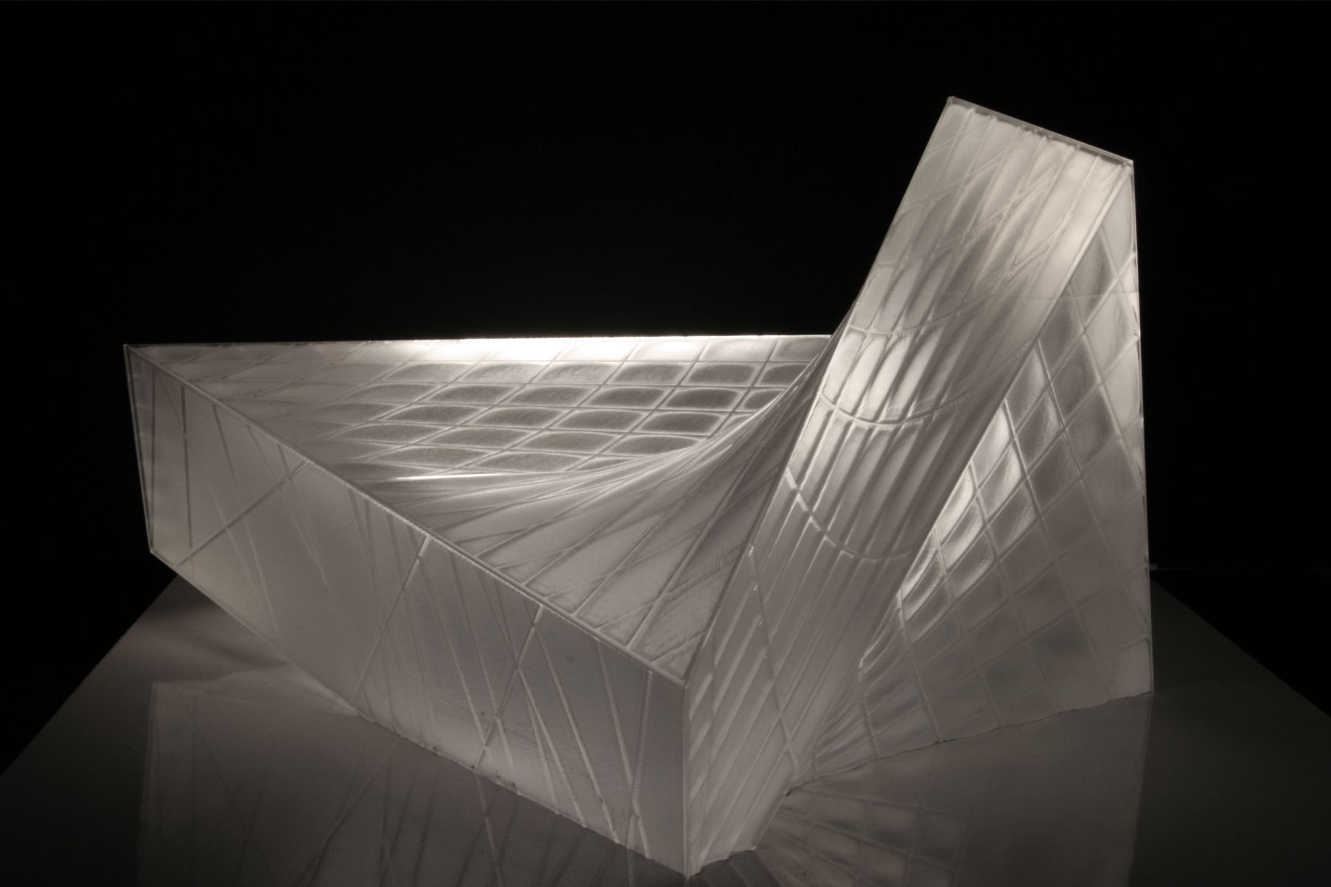 This crystalline envelope shelters the visitor without cutting him or her off from the surrounding landscape. As a mental space for prayer rather than an isolated enclosure, the landscape is of essential atmospheric importance and is invited to interact with the building’s interior. The technological functions necessary for a modern theatre are submerged in the ground so that the stage can be used flexibly for a range of purposes.