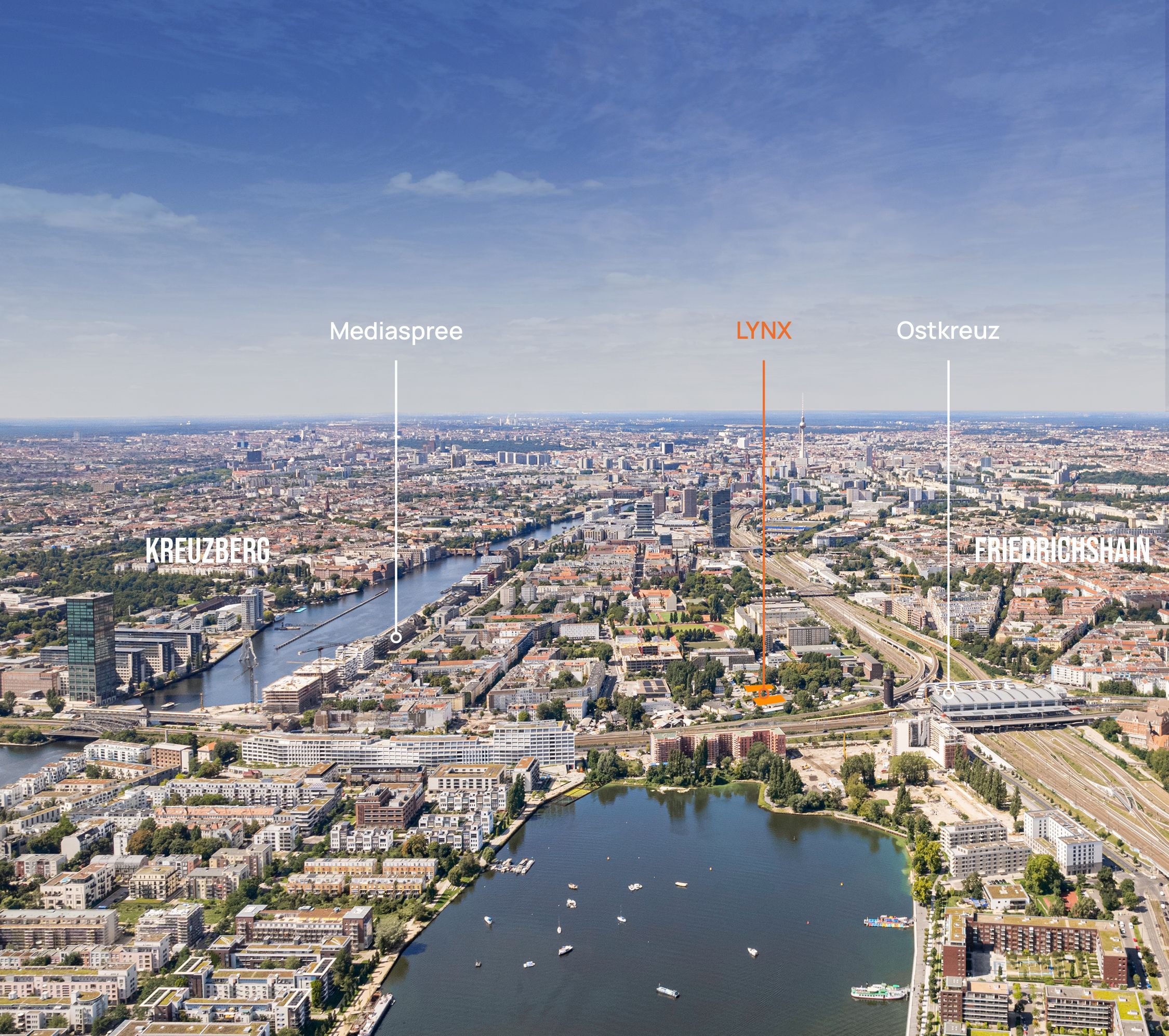 Aerial view of Berlin showing the Spree River flowing through the city, numerous buildings, green spaces, and boats on a lake in the foreground under a partly cloudy sky.