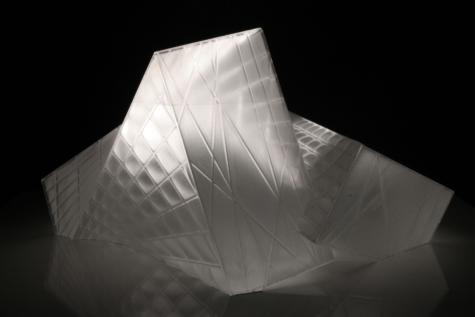 This crystalline envelope shelters the visitor without cutting him or her off from the surrounding landscape. As a mental space for prayer rather than an isolated enclosure, the landscape is of essential atmospheric importance and is invited to interact with the building’s interior. The technological functions necessary for a modern theatre are submerged in the ground so that the stage can be used flexibly for a range of purposes.