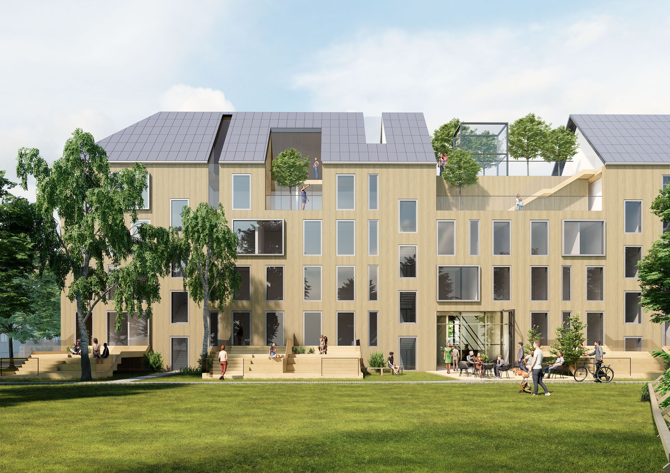 Modern three-story building with large windows, rooftop terrace with trees, and people walking and sitting outside on a lawn