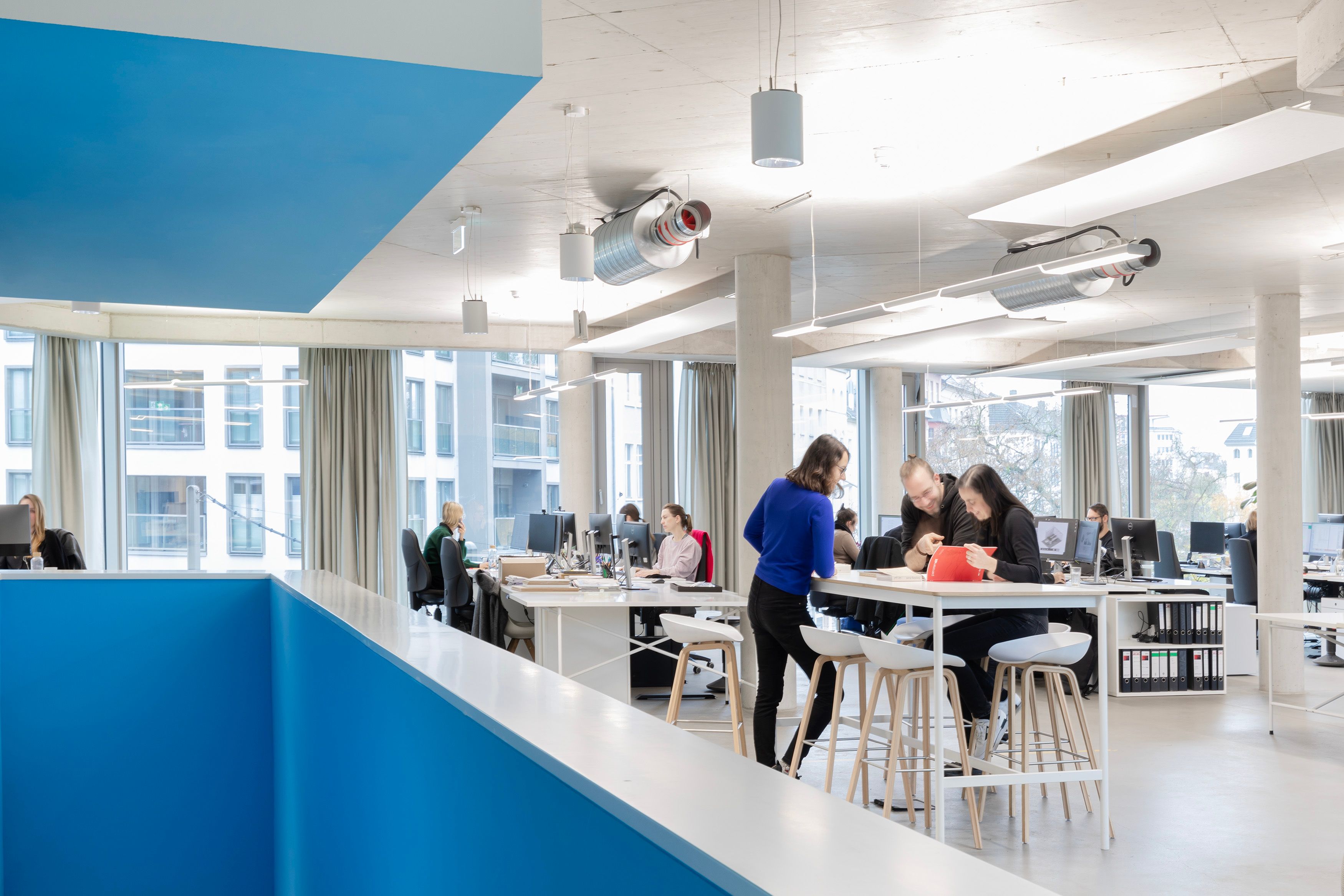 office floor with working spaces and a high table