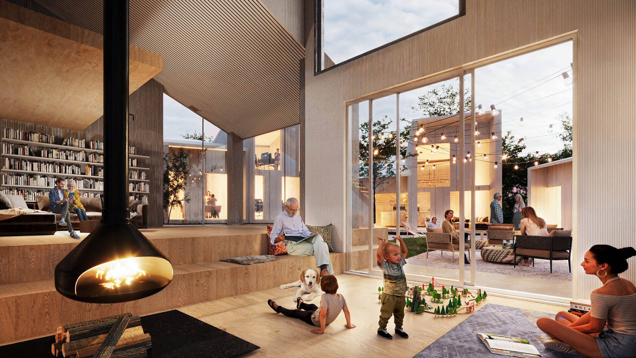 Modern living room with tiered wooden seating, a hanging fireplace, large windows, and children playing on the floor with adults seated around